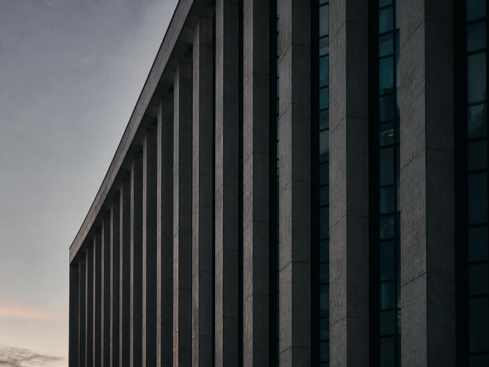 Facade of a European institutional building at dusk